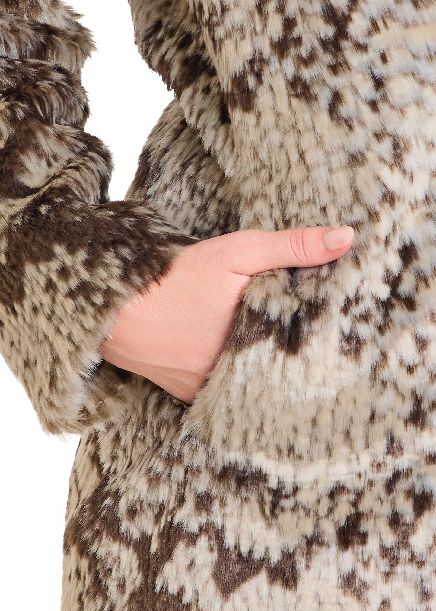 Close-up of a hand in a fur coat with a patterned background