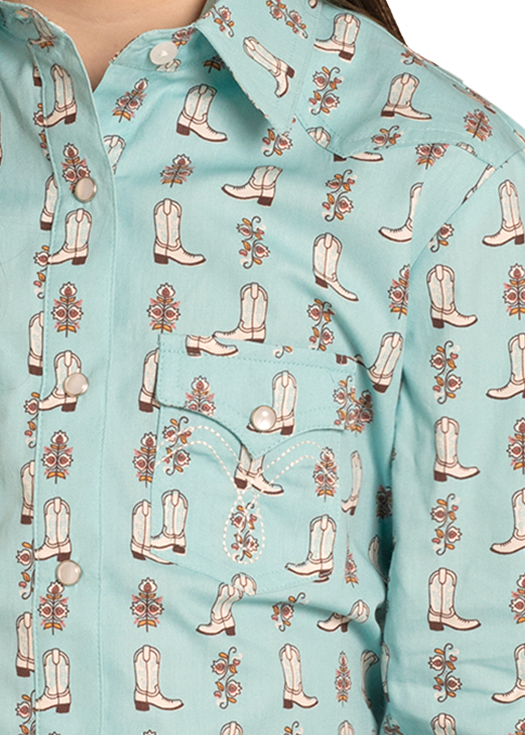 Child wearing a turquoise long-sleeve shirt with cowboy boot pattern, blue jeans, and beige cowboy hat on a white background.