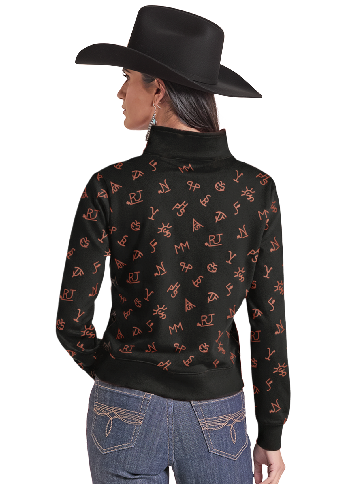 A woman shown from the back wearing a black mock-neck long-sleeve top with an allover orange cowboy-themed monogram pattern, paired with blue jeans and a black cowboy hat.