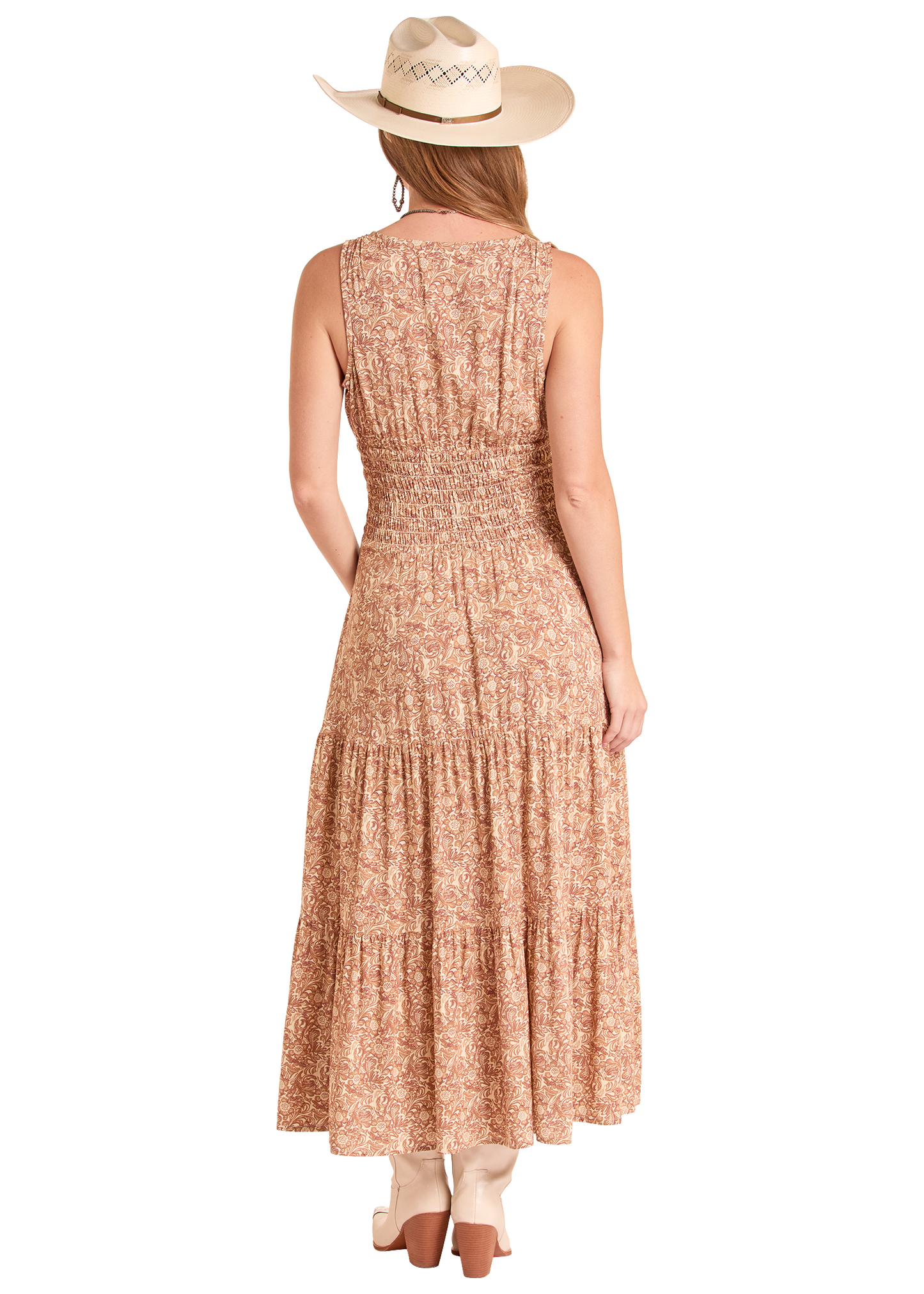 Woman wearing a long, patterned dress with a white background