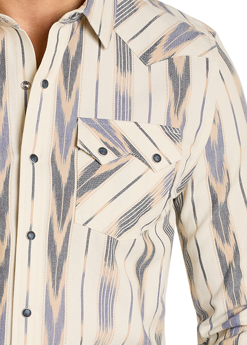 Man wearing a patterned long-sleeve shirt and jeans on a white background