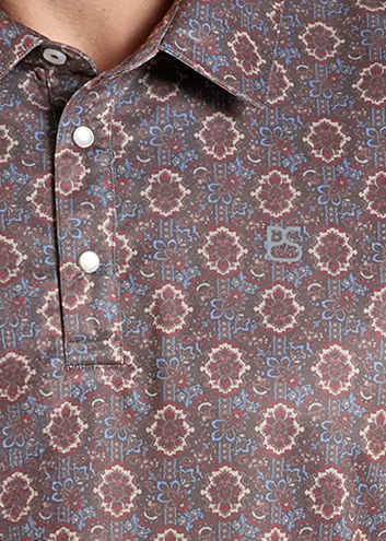 Detail image of a polo shirt with a brown and beige geometric pattern.