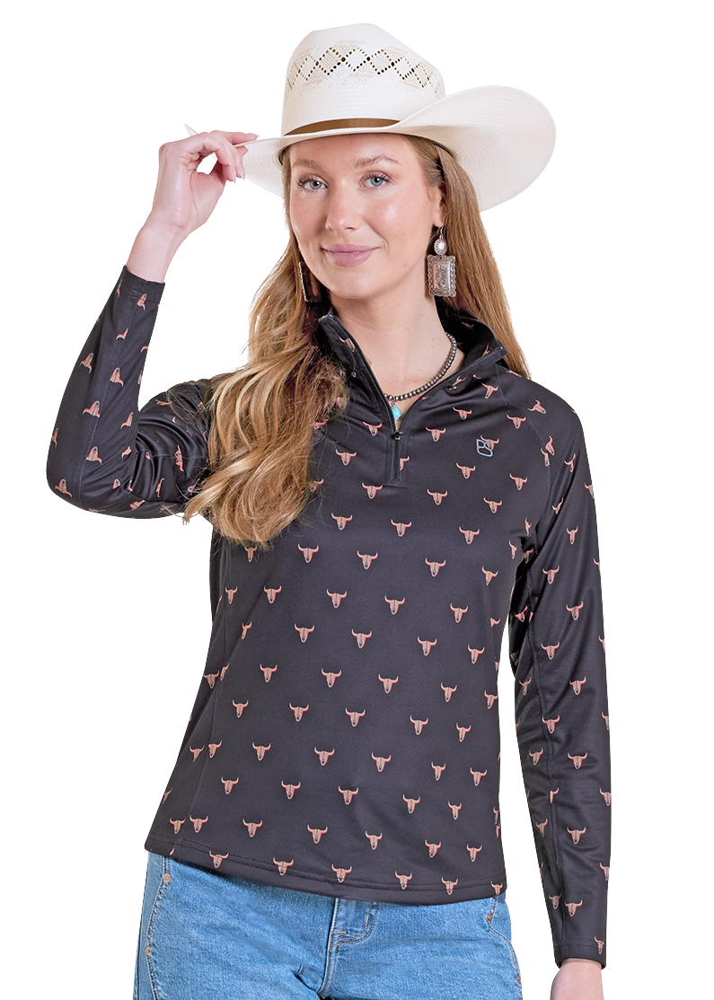 Woman wearing a performance pullover quarter-zip with skulls on it.