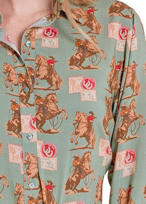 Woman wearing a patterned shirt, denim shorts, and white cowboy boots on a white background