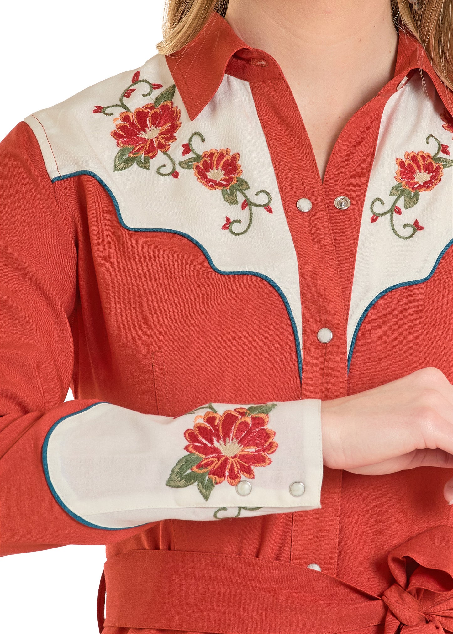 Red blouse with floral embroidery on a white background
