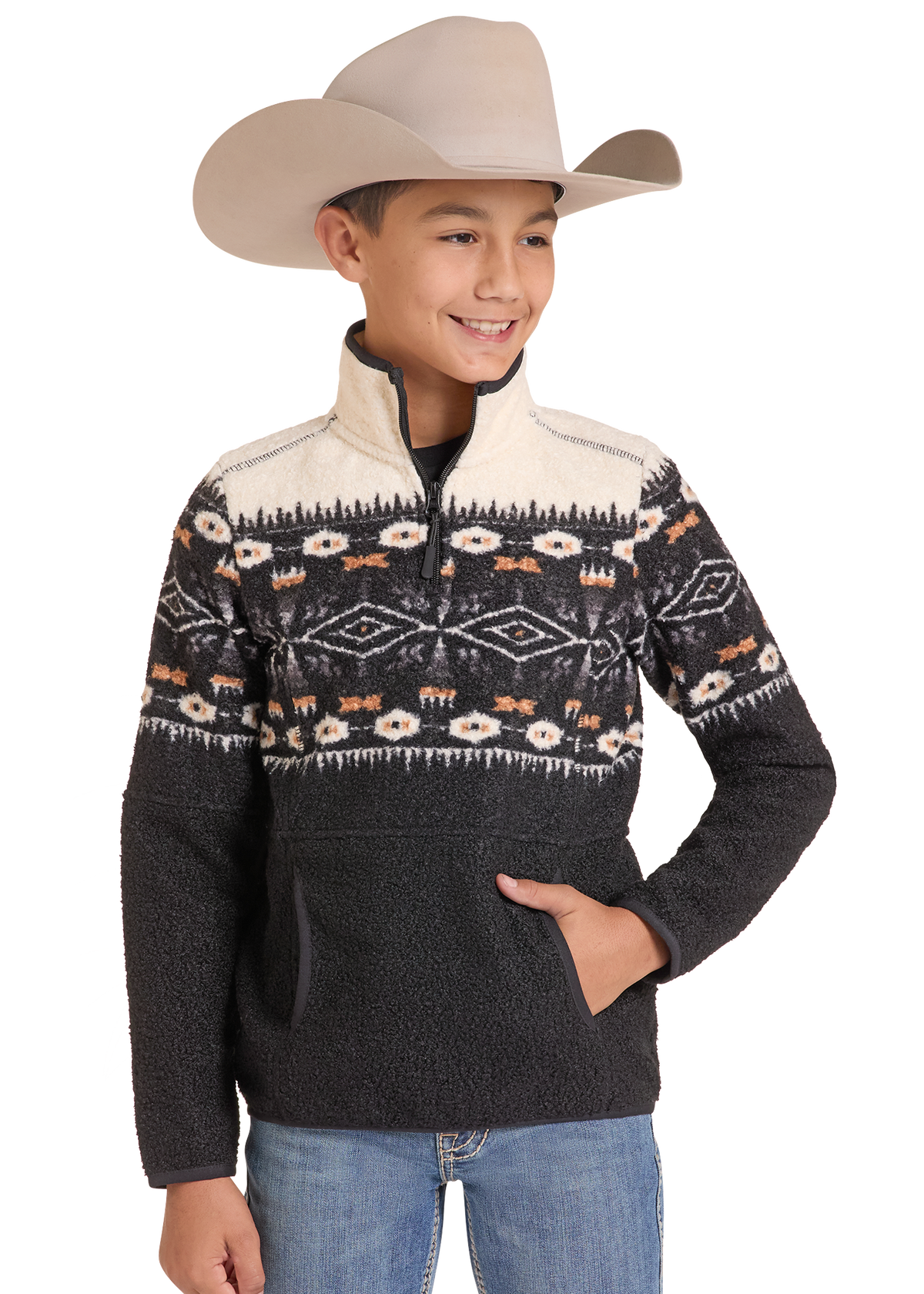 A young boy wearing a beige cowboy hat and a dark gray quarter-zip fleece pullover sweater with a cream and multicolor patterned yoke, paired with blue jeans.