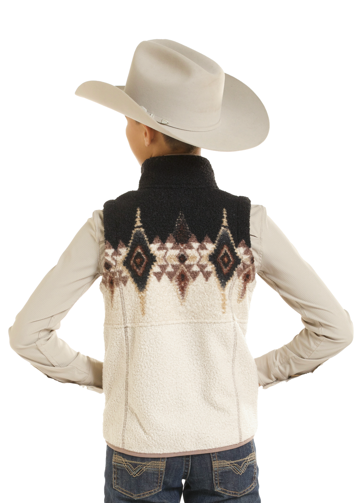 A child viewed from the back wearing a cream sherpa fleece vest with a black yoke and a brown Southwestern diamond pattern, paired with a cream cowboy hat, cream long-sleeve shirt, and blue jeans.