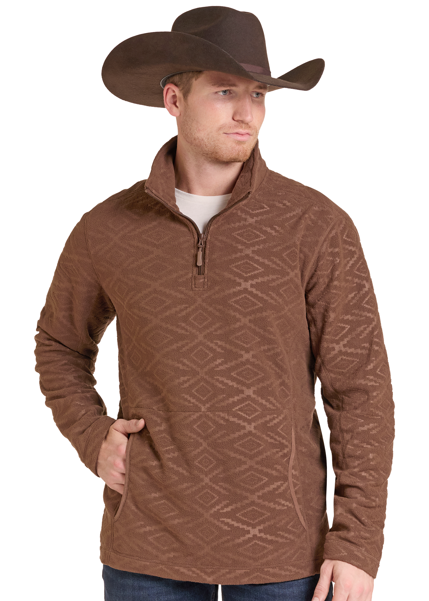 A man wearing a brown quarter-zip fleece pullover with a subtle geometric diamond pattern, paired with a brown cowboy hat and blue jeans.