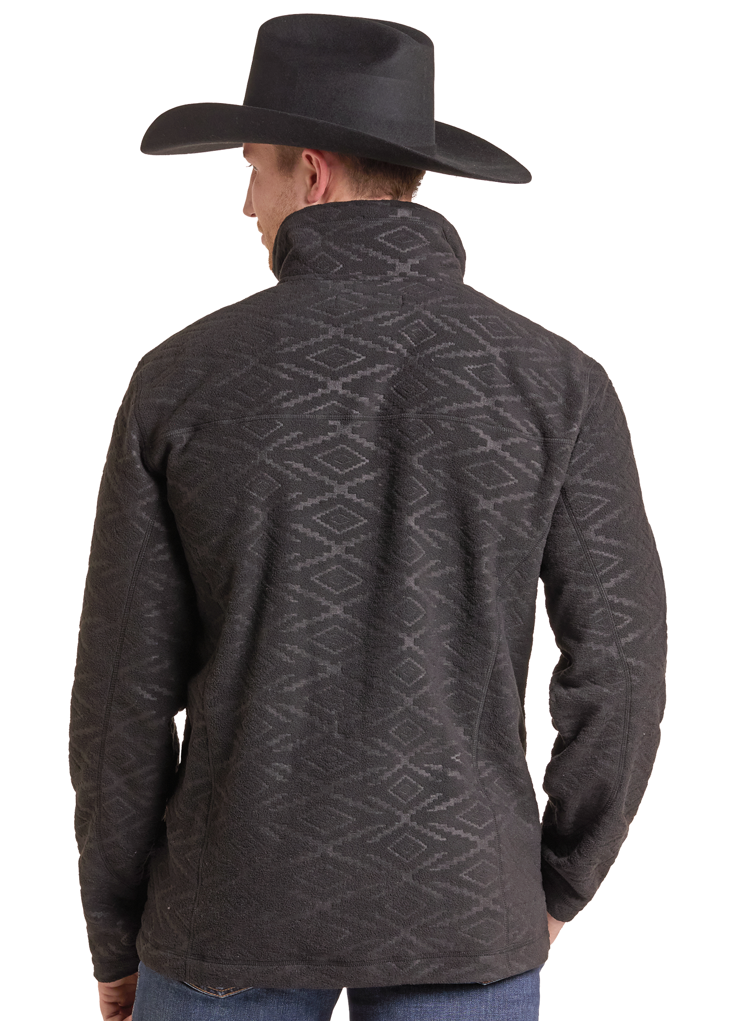 A man shown from the back wearing a dark charcoal gray fleece pullover with a subtle geometric diamond pattern, paired with a black cowboy hat and blue jeans.