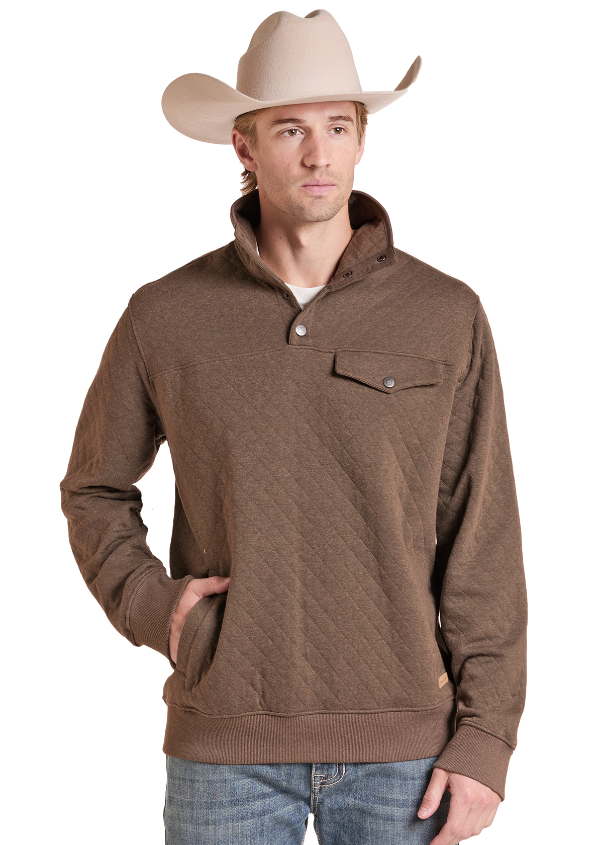 A man wearing a brown quilted long-sleeve pullover sweater with a stand collar and chest pocket, paired with a beige cowboy hat and blue jeans.