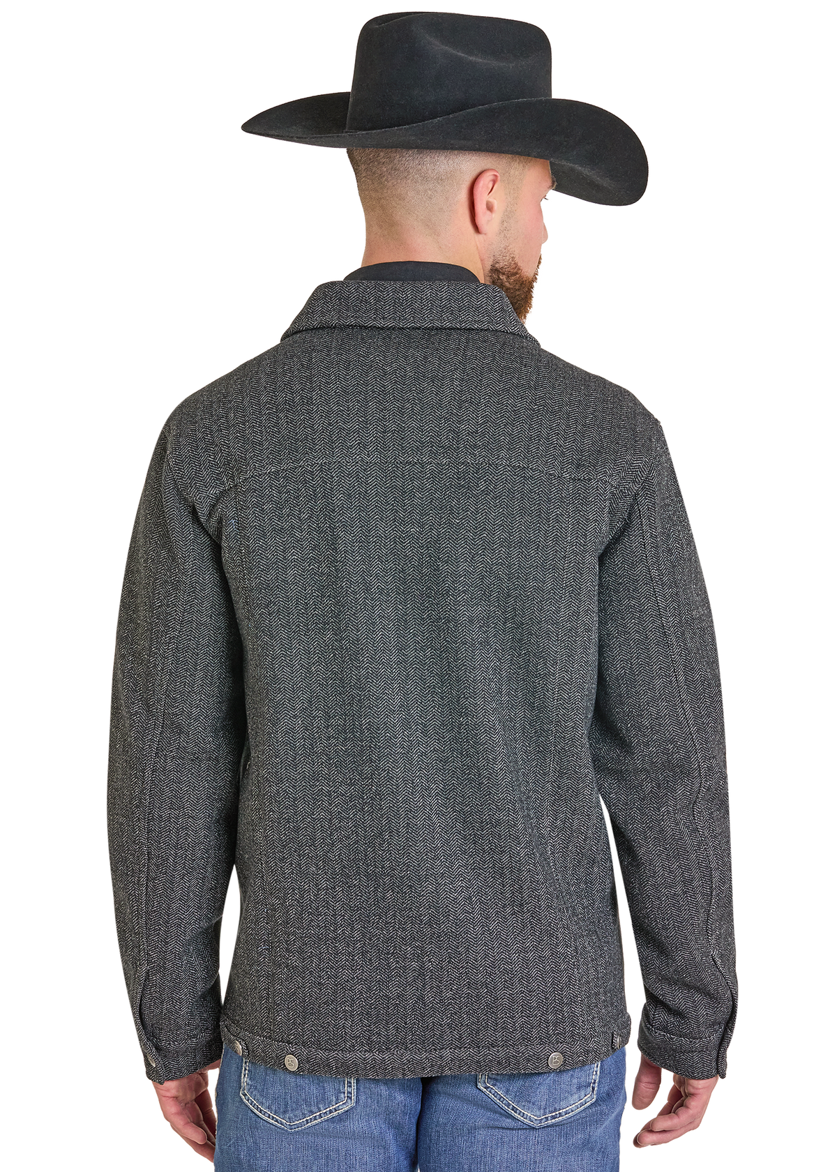 A man viewed from the back wearing a dark gray textured button-up jacket, a black cowboy hat, and blue jeans against a plain white background.