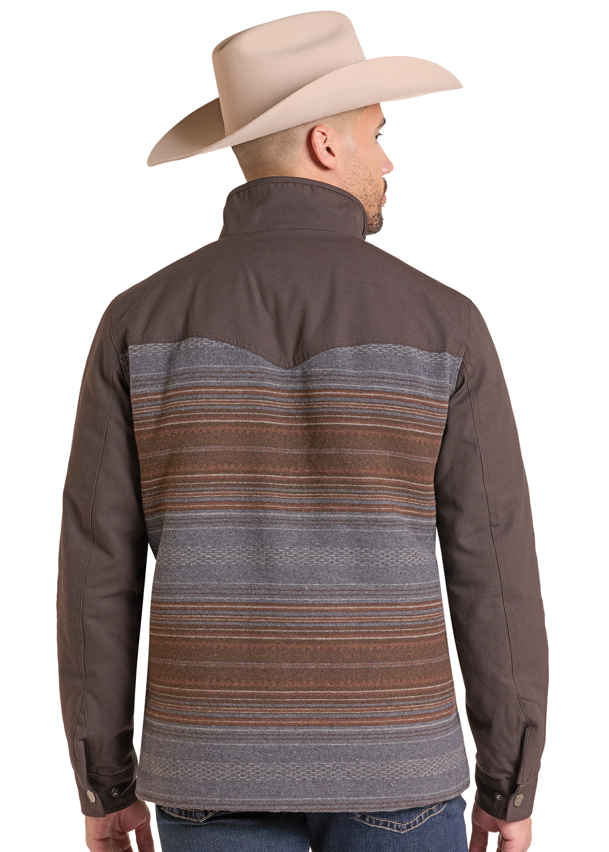 A man wearing a brown western-style shirt jacket with a striped wool-like back panel, shown from the back. He is also wearing a beige cowboy hat and blue jeans.