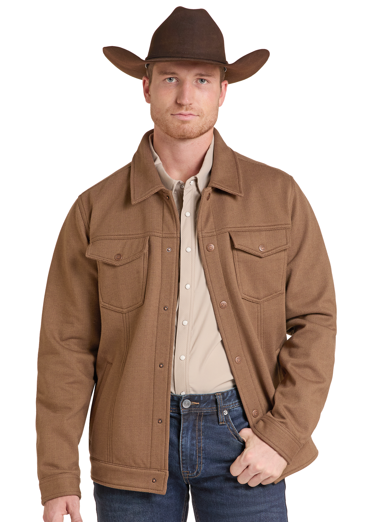 A man wearing a brown cowboy hat, a brown button-front jacket over a light beige shirt, and blue jeans, photographed against a plain white studio background.