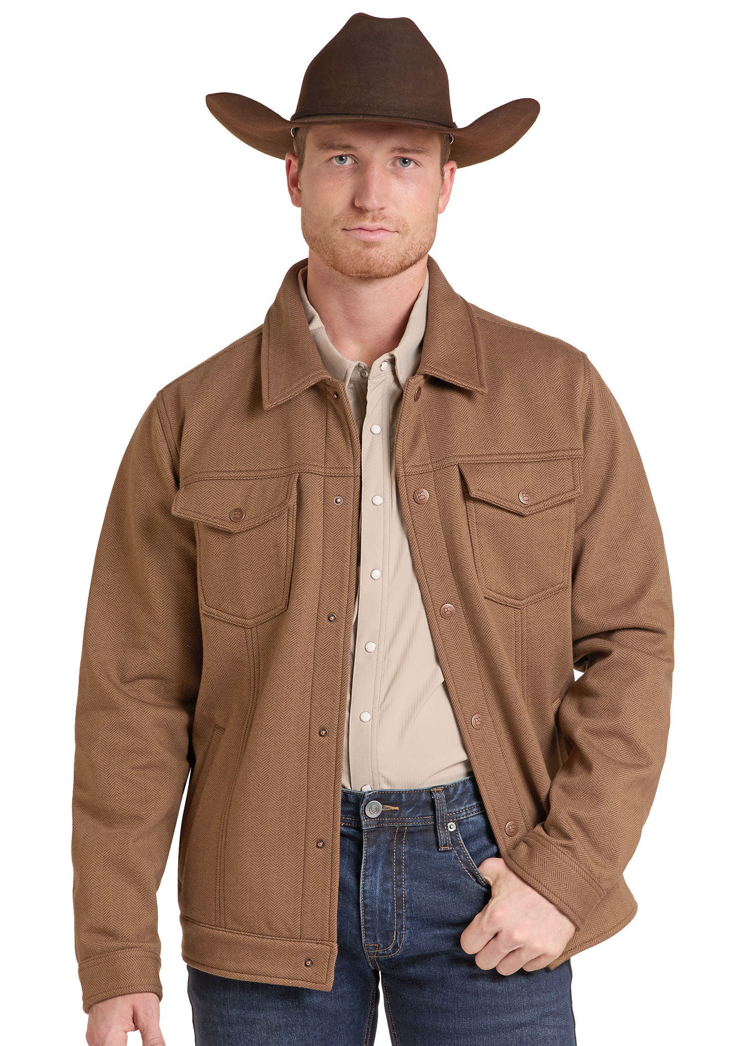 A man wearing a brown cowboy hat, a brown button-front jacket over a light beige shirt, and blue jeans, photographed against a plain white studio background.