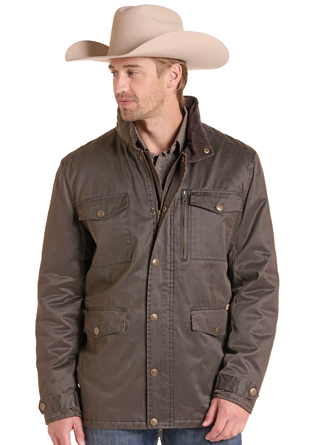 A man wearing a brown waxed cotton western jacket with a high collar and snap buttons, paired with a beige cowboy hat and blue jeans.