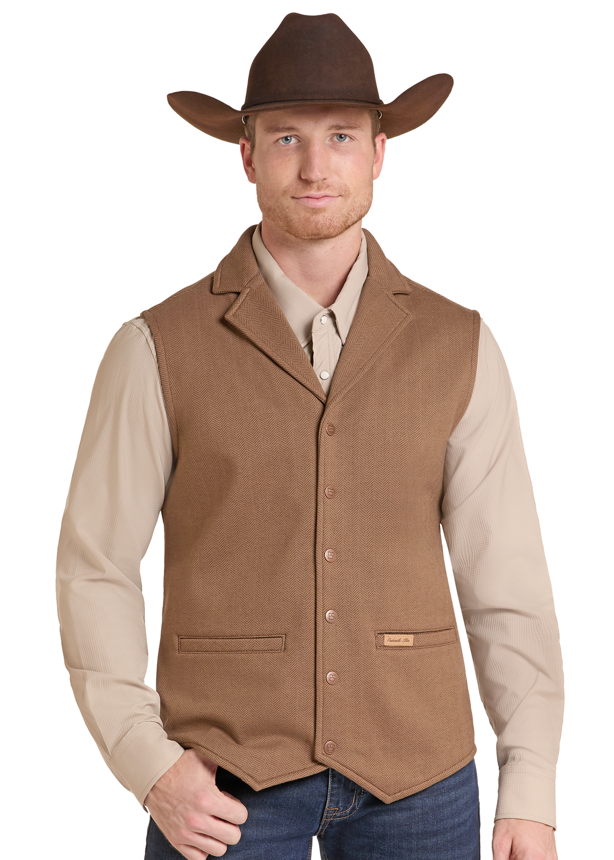 A man wearing a brown cowboy hat, tan long-sleeve shirt, and brown button-front vest.