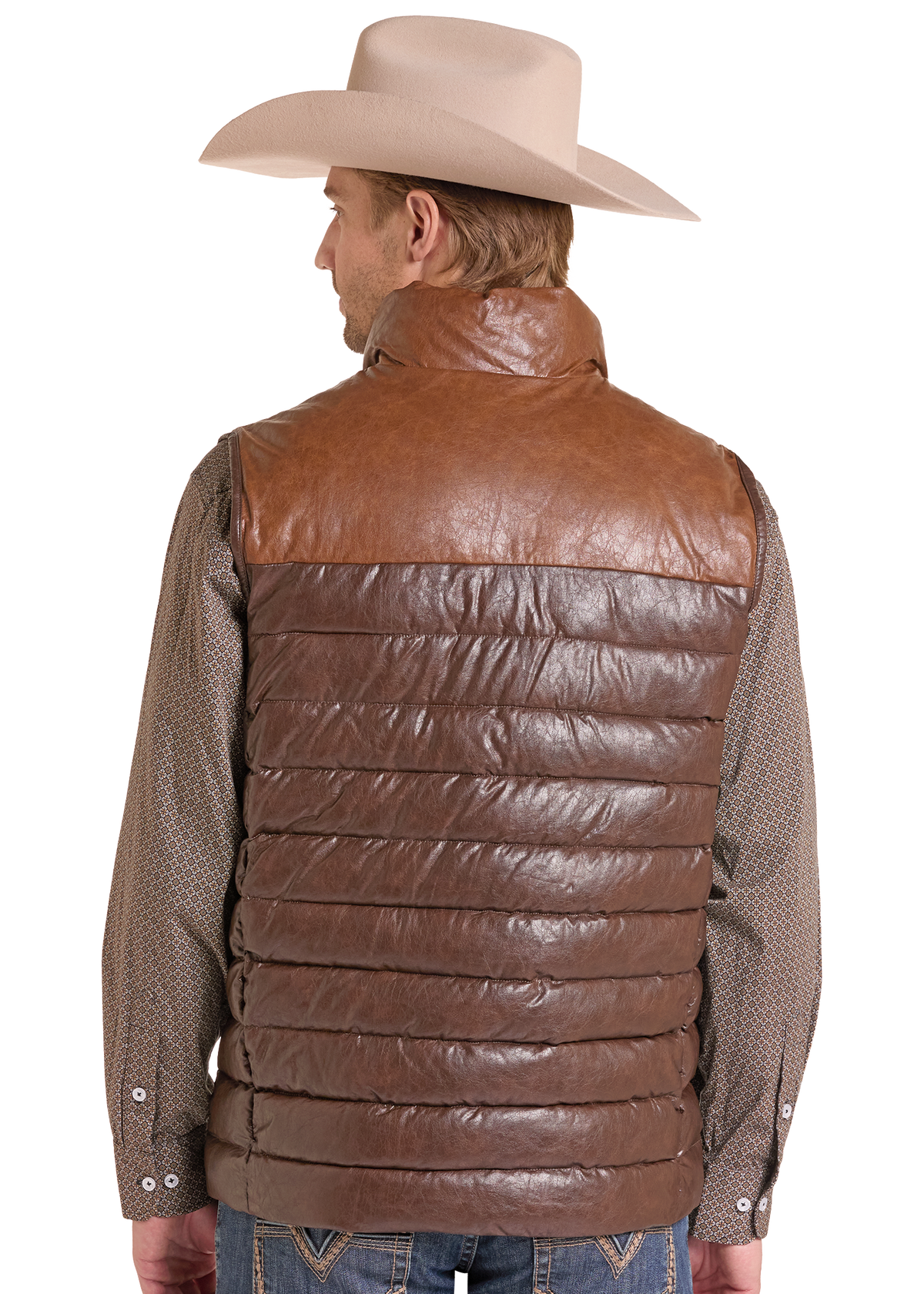 A man shown from the back wearing a brown faux-leather quilted vest over a patterned brown shirt, blue jeans, and a beige cowboy hat.