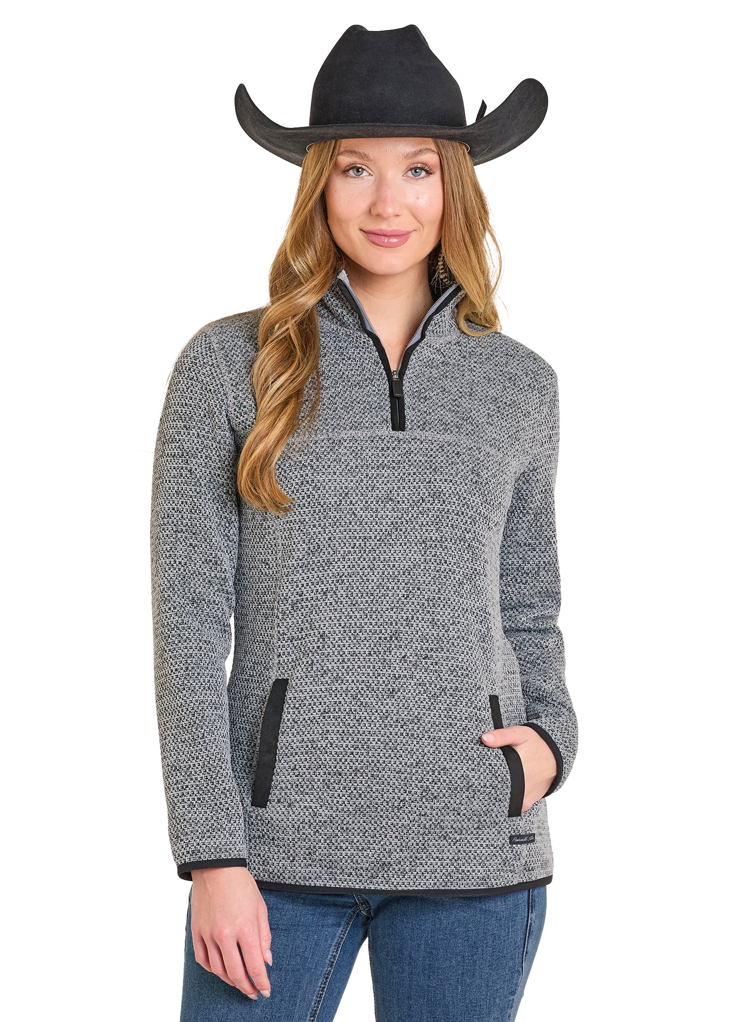 Woman wearing a gray sweater with black accents and a black cowboy hat on a white background