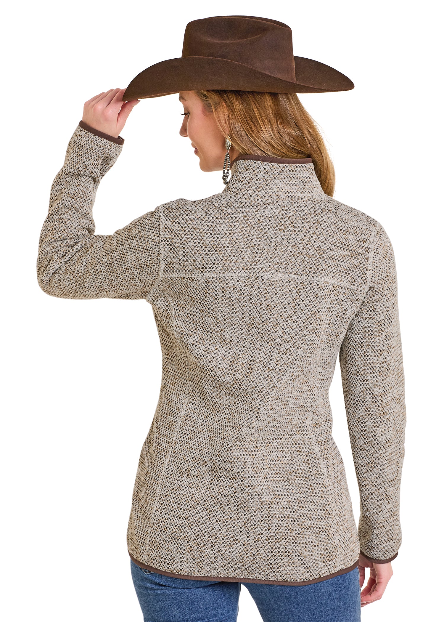 Woman wearing a textured gray jacket and brown cowboy hat on a white background