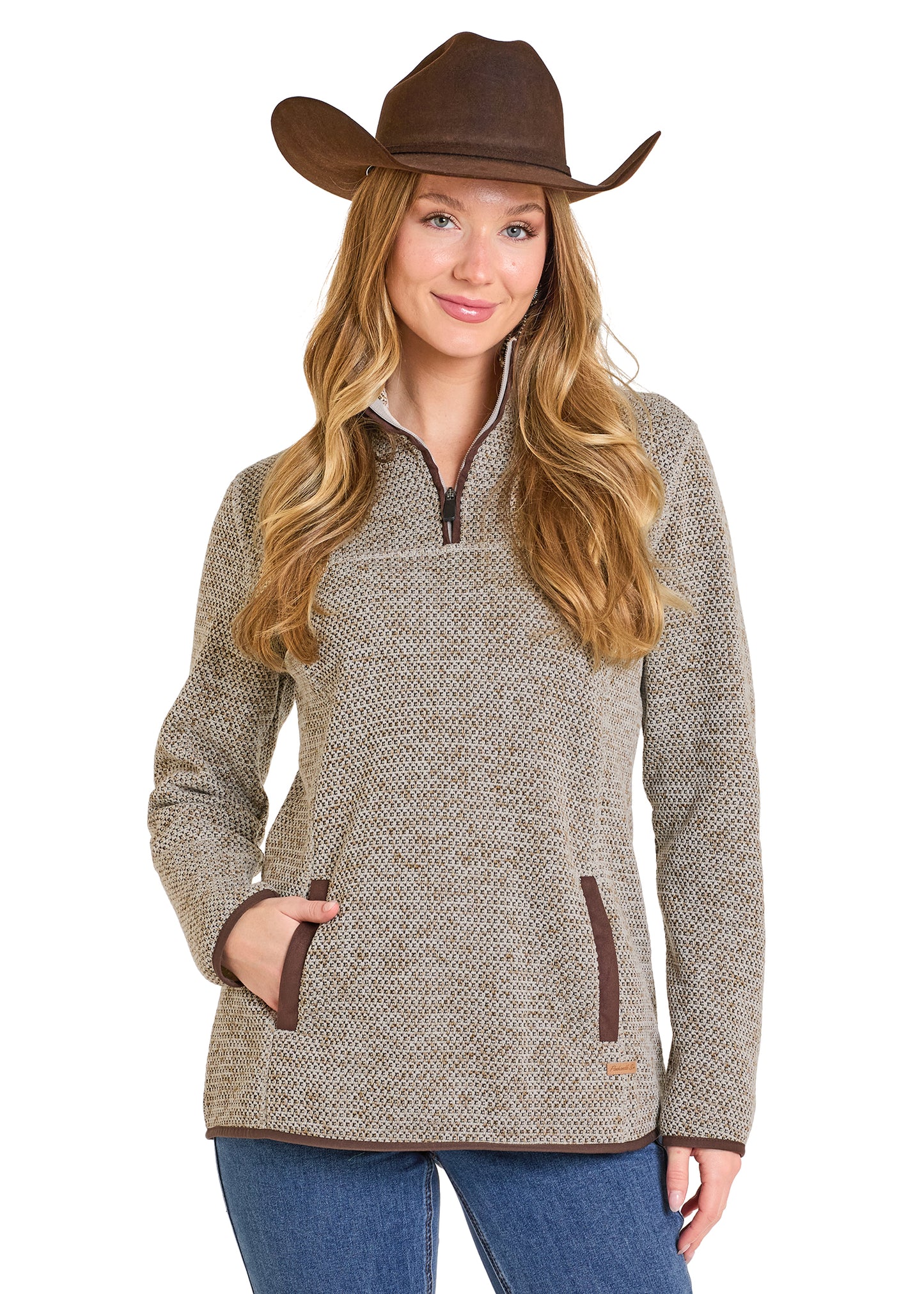 Woman wearing a brown cowboy hat and a patterned sweater on a white background