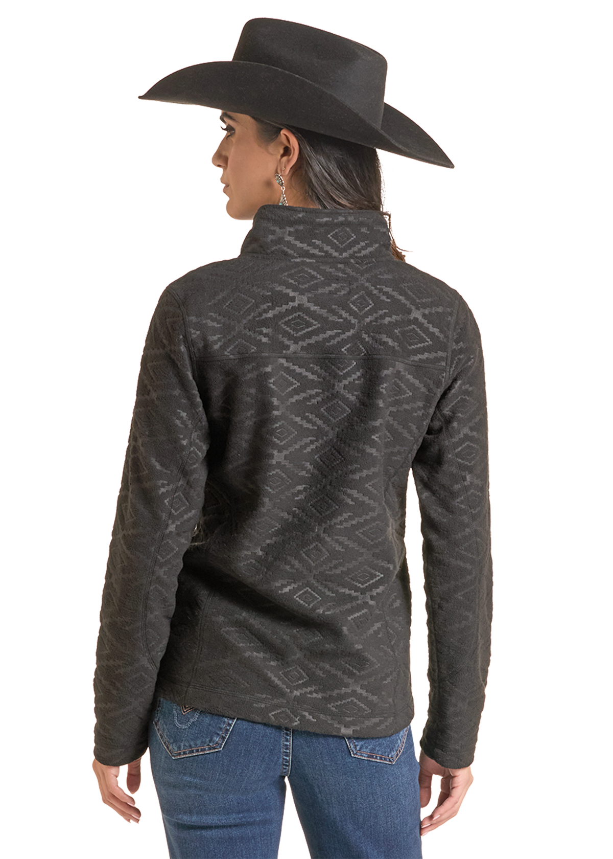 A woman shown from the back wearing a dark charcoal gray patterned quarter-zip fleece jacket, blue jeans, and a black cowboy hat.