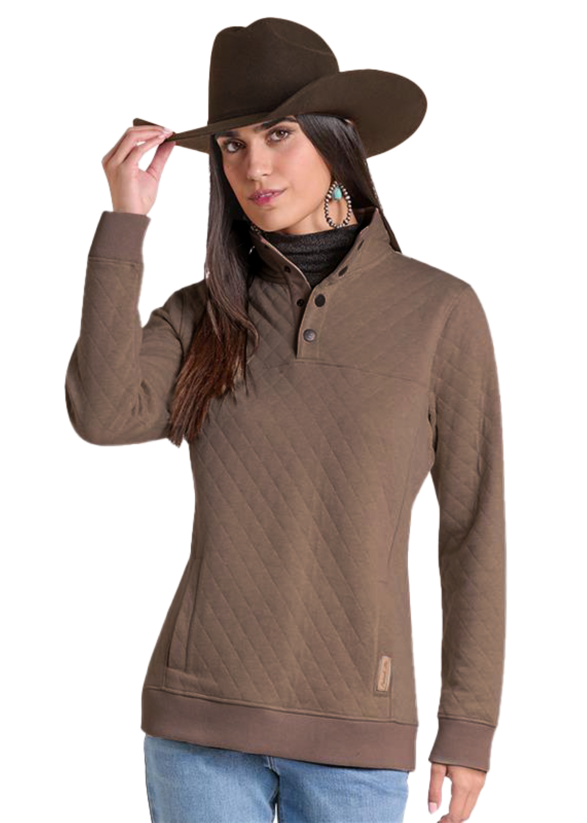 A woman wearing a brown quilted long-sleeve quarter-zip pullover sweater, a matching brown cowboy hat, and blue jeans.