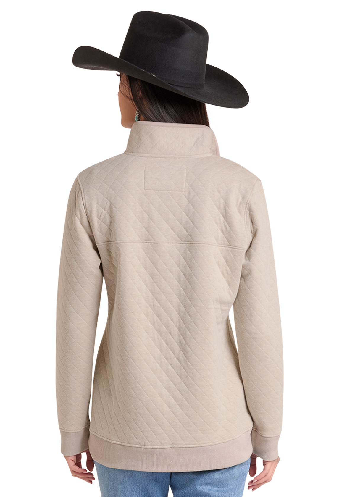 A woman shown from the back wearing a beige quilted long-sleeve jacket and a black cowboy hat.