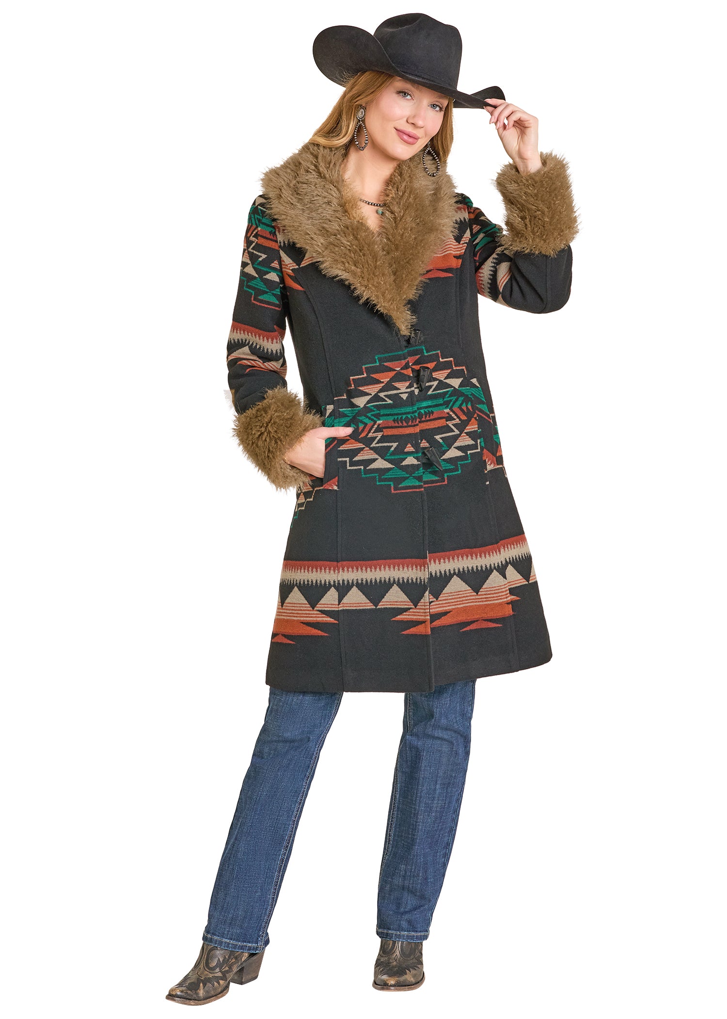 Woman wearing a patterned coat with fur trim and a cowboy hat on a white background