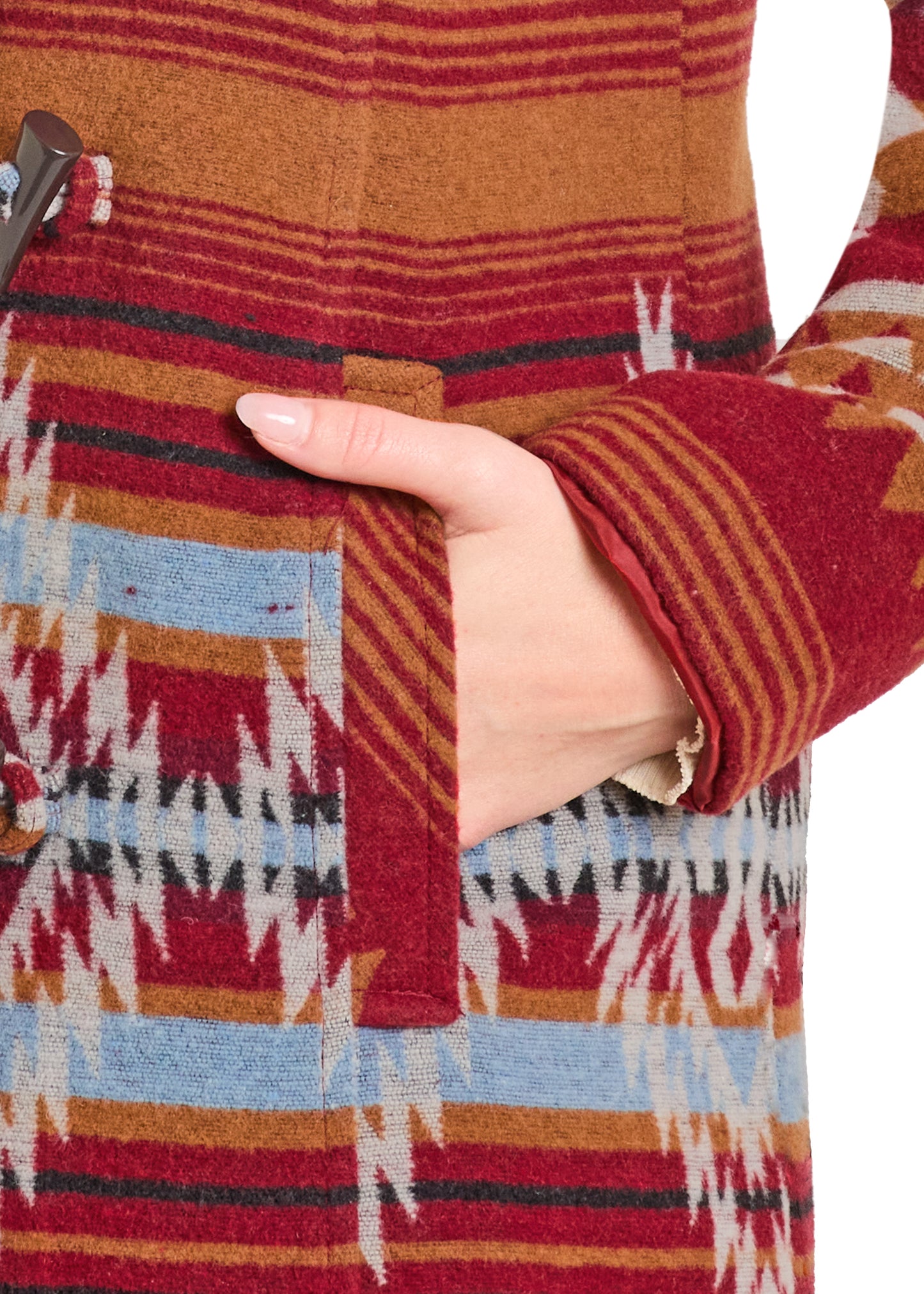 Close-up of a colorful patterned fabric with a hand holding it