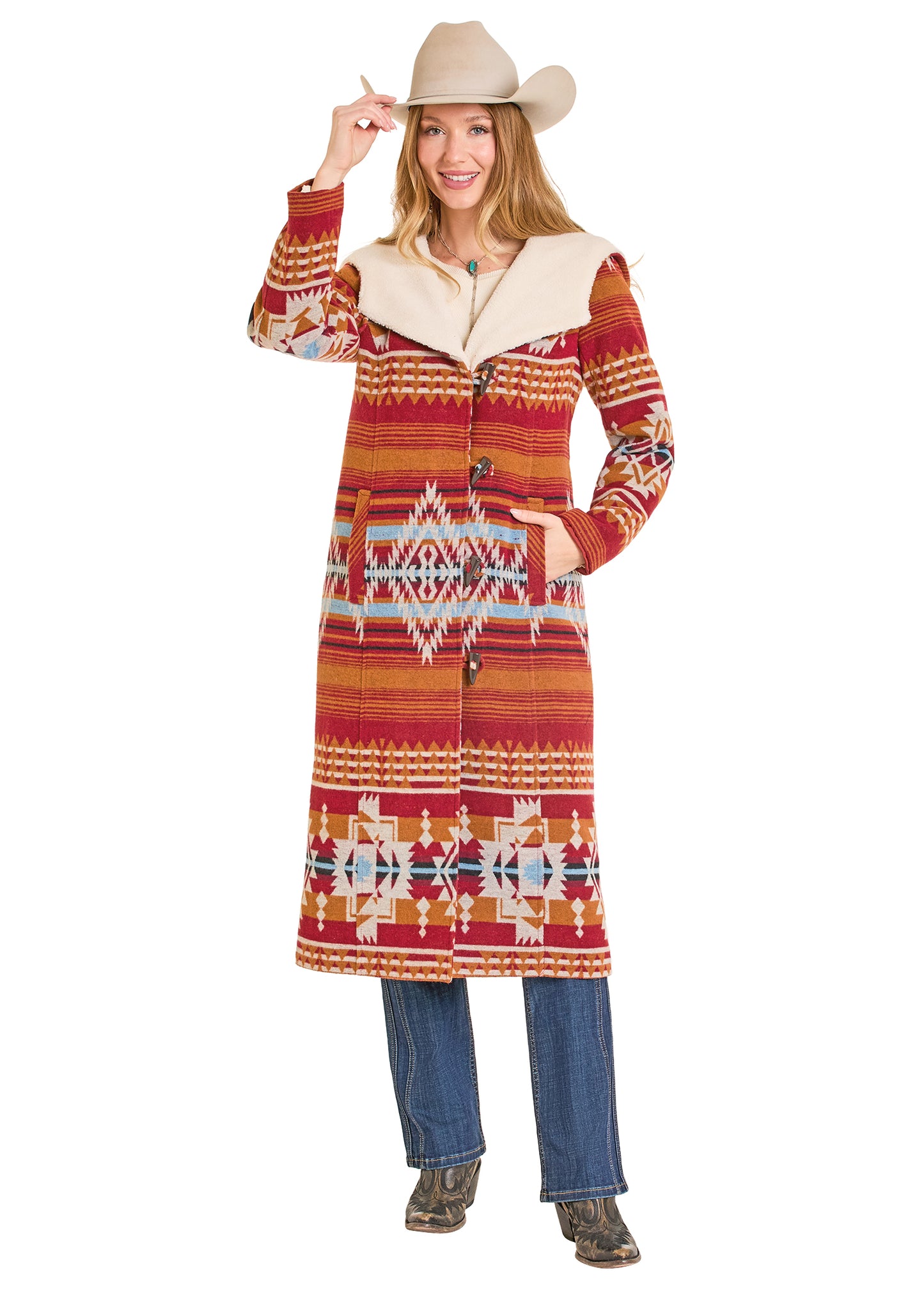 Woman wearing a patterned coat and cowboy hat on a white background