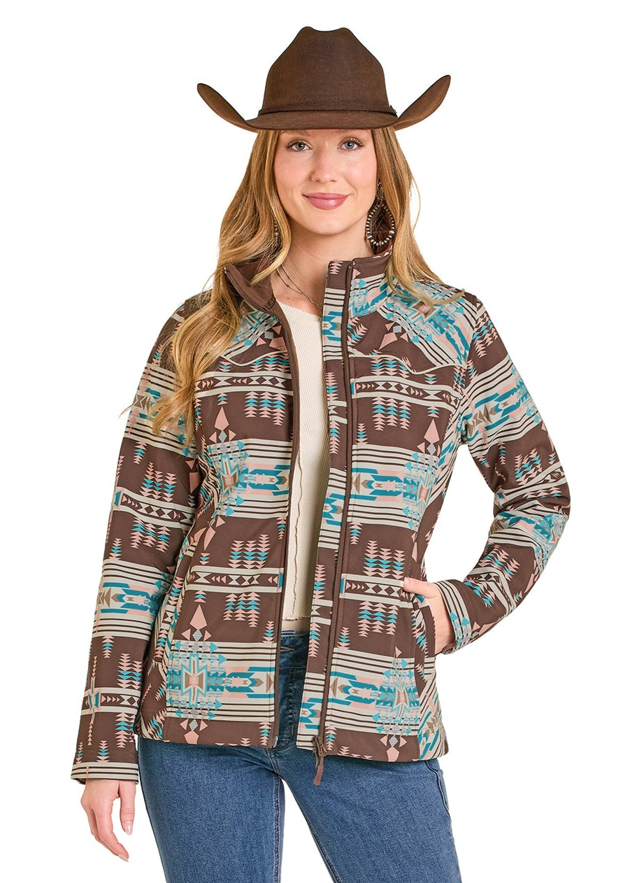 Woman wearing a patterned jacket, jeans, and a cowboy hat on a white background