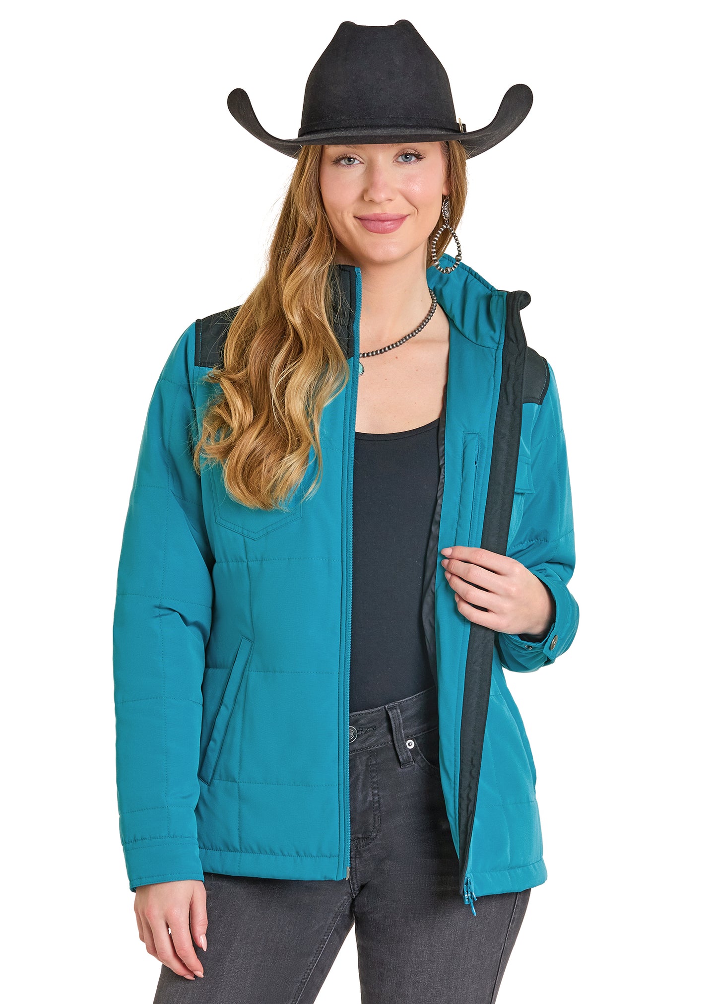 Woman wearing a teal jacket and black cowboy hat on a white background