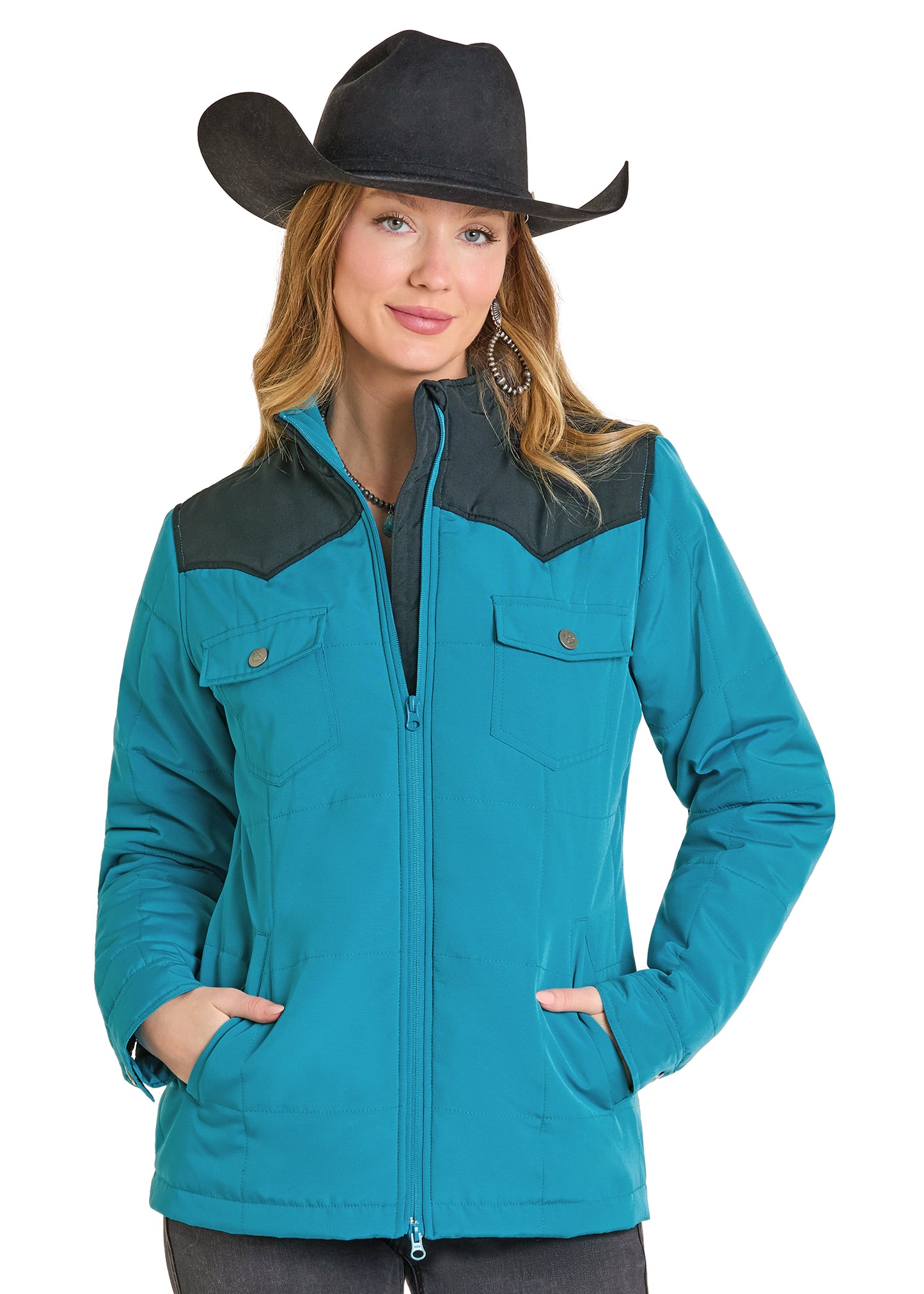 Woman wearing a turquoise jacket with black accents and a black cowboy hat on a white background