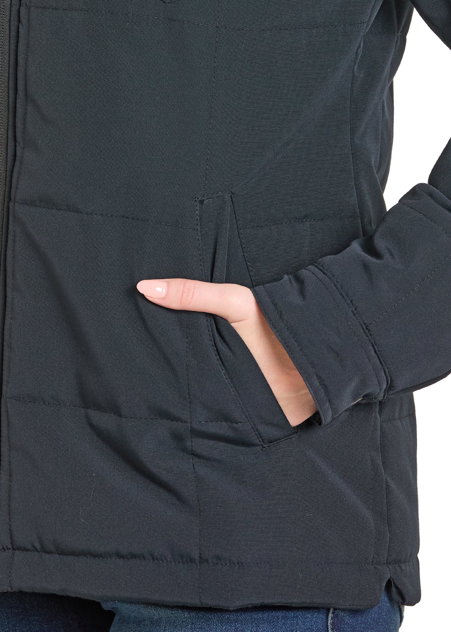 Close-up of a person wearing a dark gray jacket with a hand in a pocket.