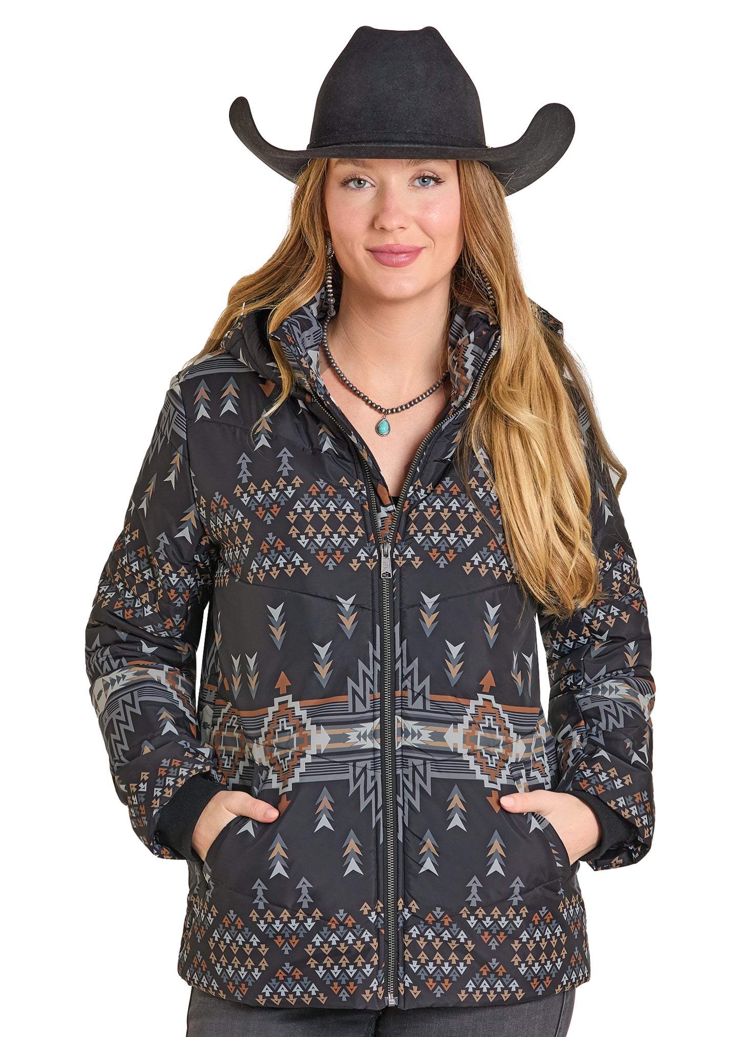 Woman wearing a patterned jacket and black cowboy hat on a white background