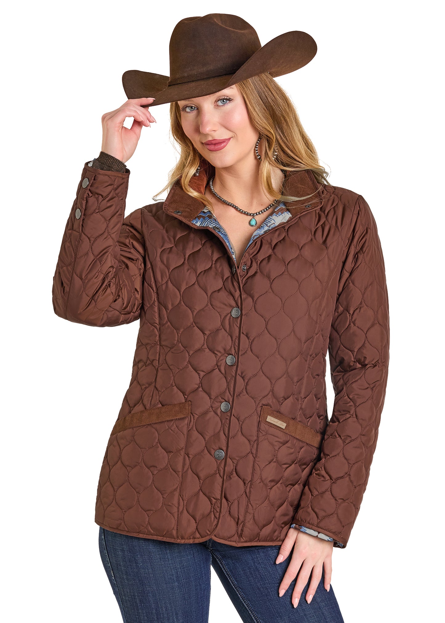 Woman wearing a brown quilted jacket and cowboy hat on a white background