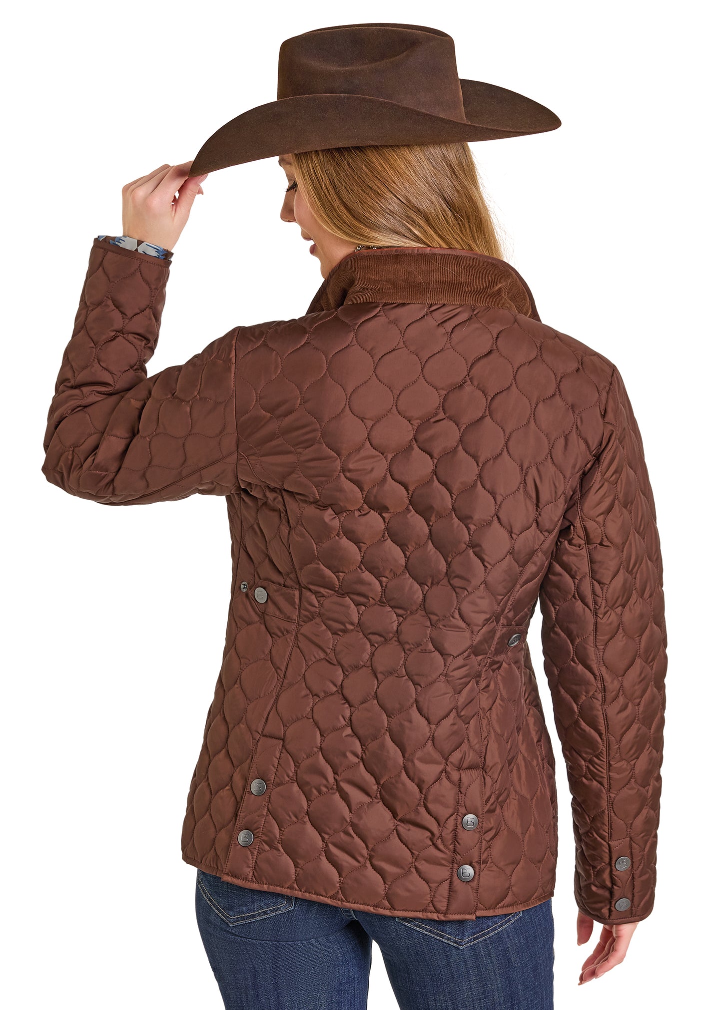 Woman wearing a brown quilted jacket and cowboy hat on a white background