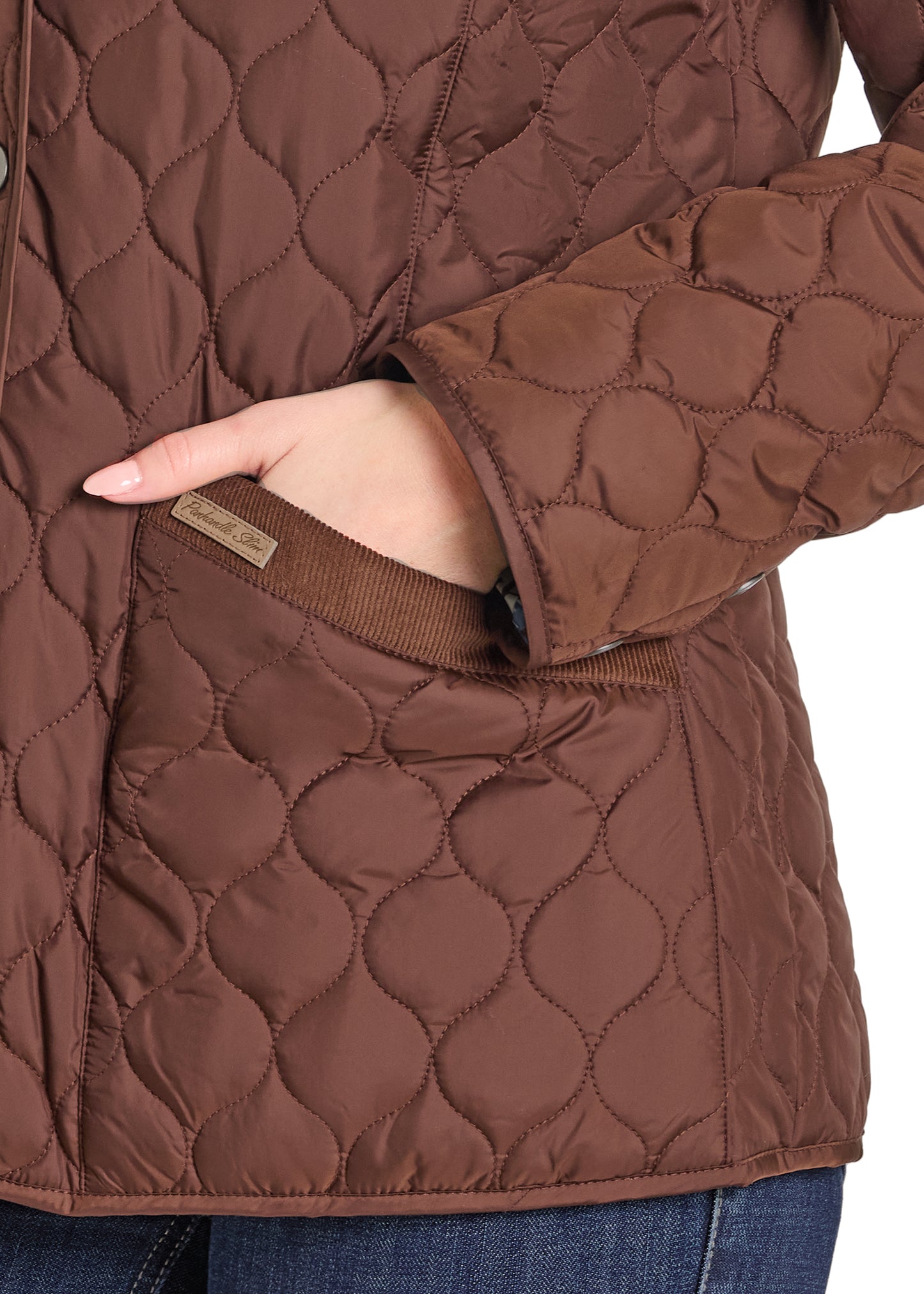 Brown quilted jacket with a close-up of the fabric texture.