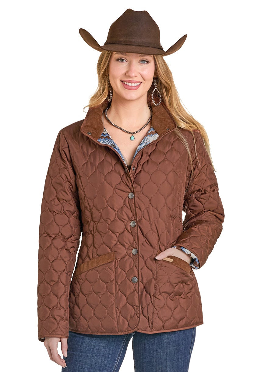 Woman wearing a brown quilted jacket and cowboy hat on a white background