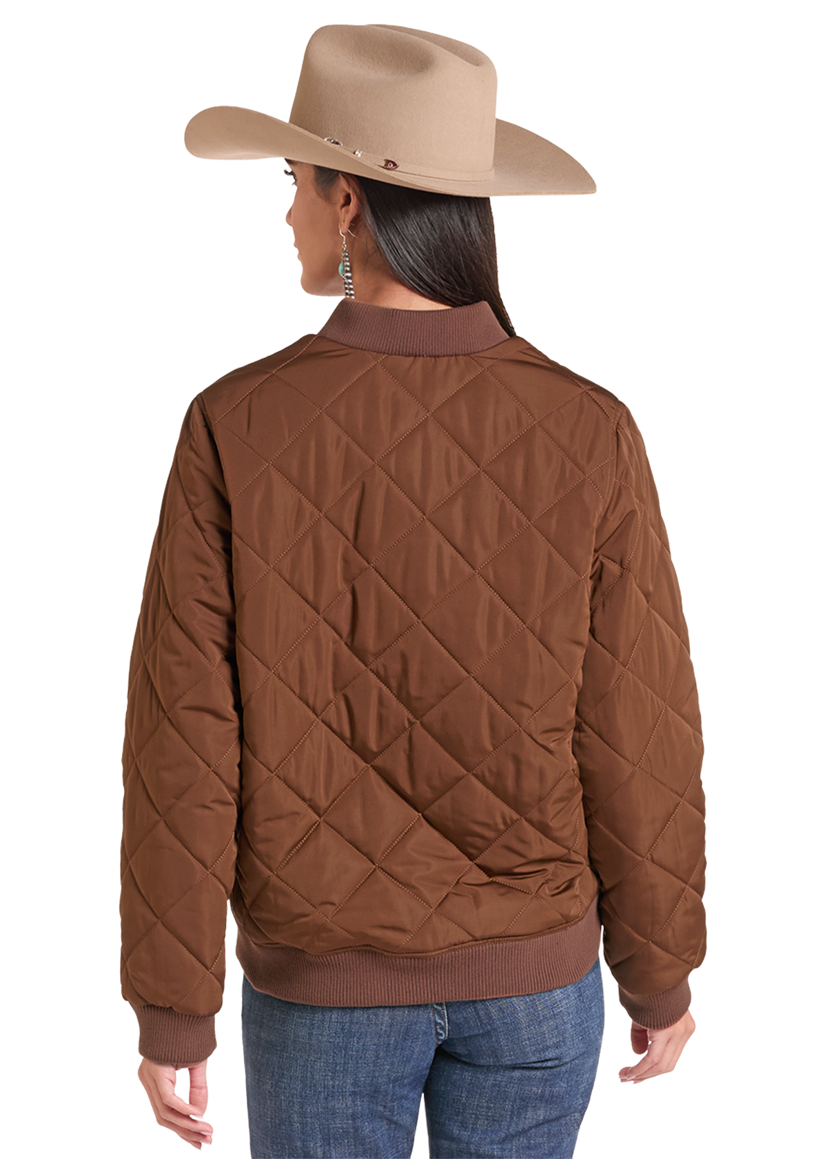 A woman shown from the back wearing a brown diamond-quilted bomber jacket, a beige cowboy hat, and blue jeans.