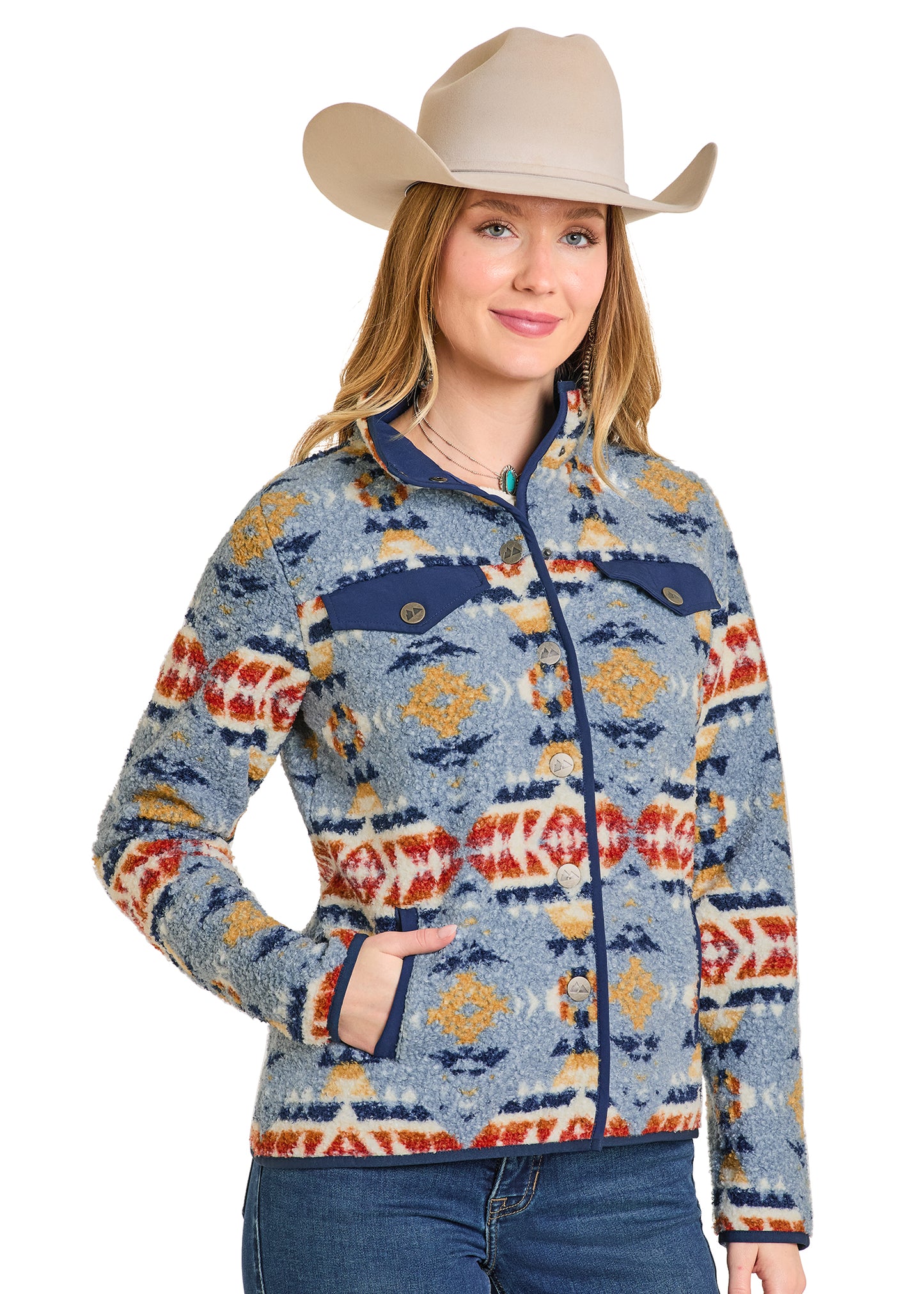 Woman wearing a patterned jacket and cowboy hat on a white background
