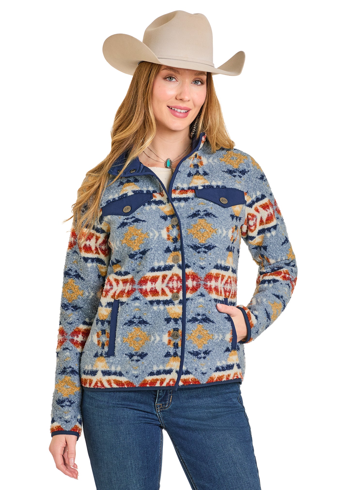 Woman wearing a patterned jacket and cowboy hat on a white background