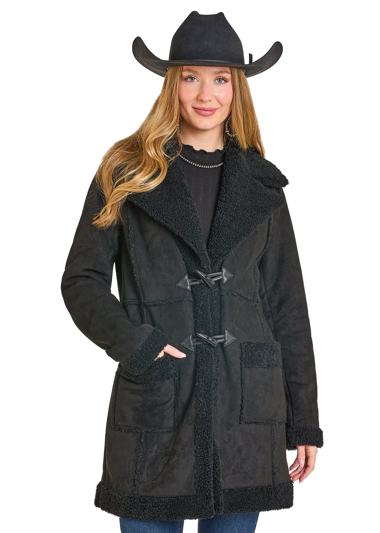 Woman wearing a black coat with a cowboy hat on a white background