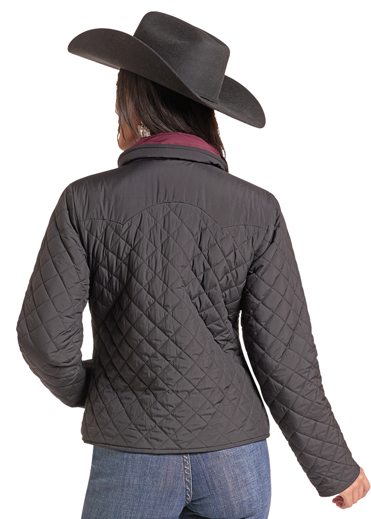 Back of a Woman wearing a black quilted zip up jacket with a cowboy hat and jeans. 