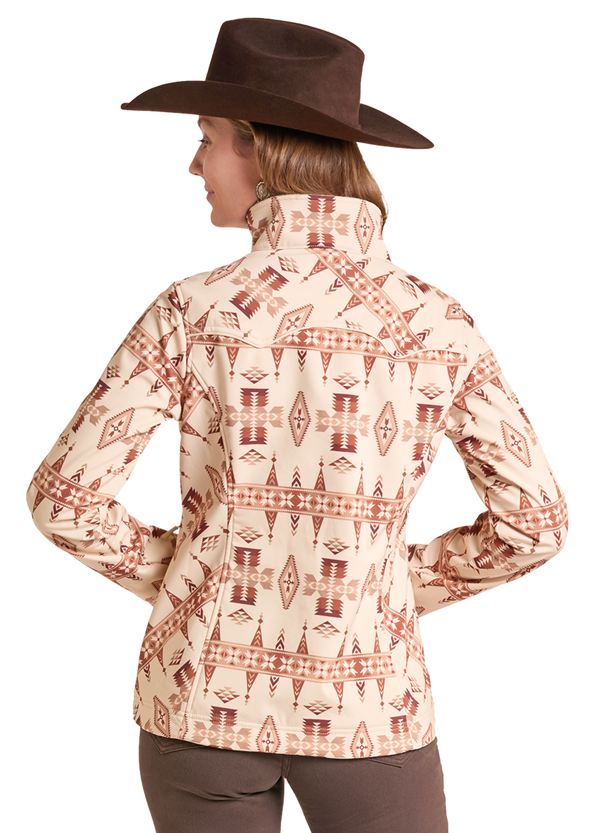 The back of a woman wearing an Aztec soft shell jacket with brown pants and a cowboy hat. 