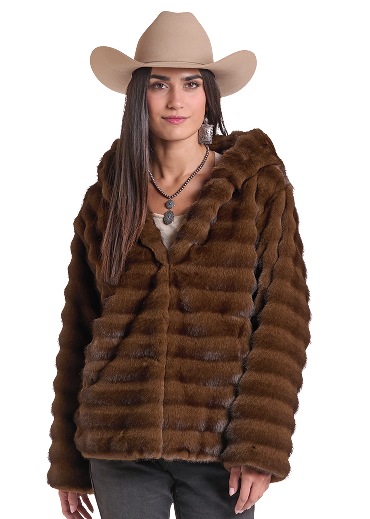 Woman wearing a brown fur coat and cowboy hat. 