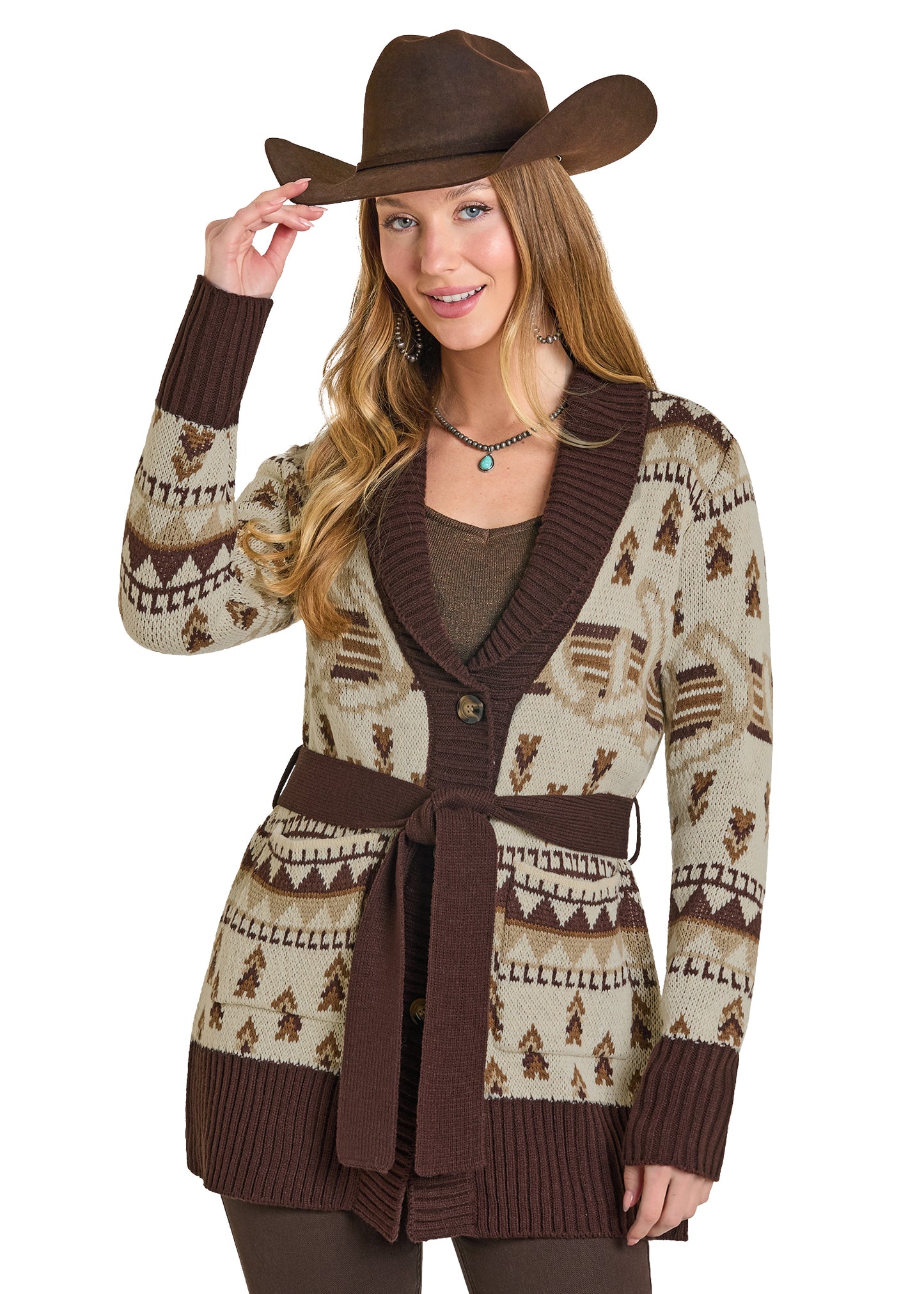 Woman wearing a patterned cardigan and cowboy hat on a white background
