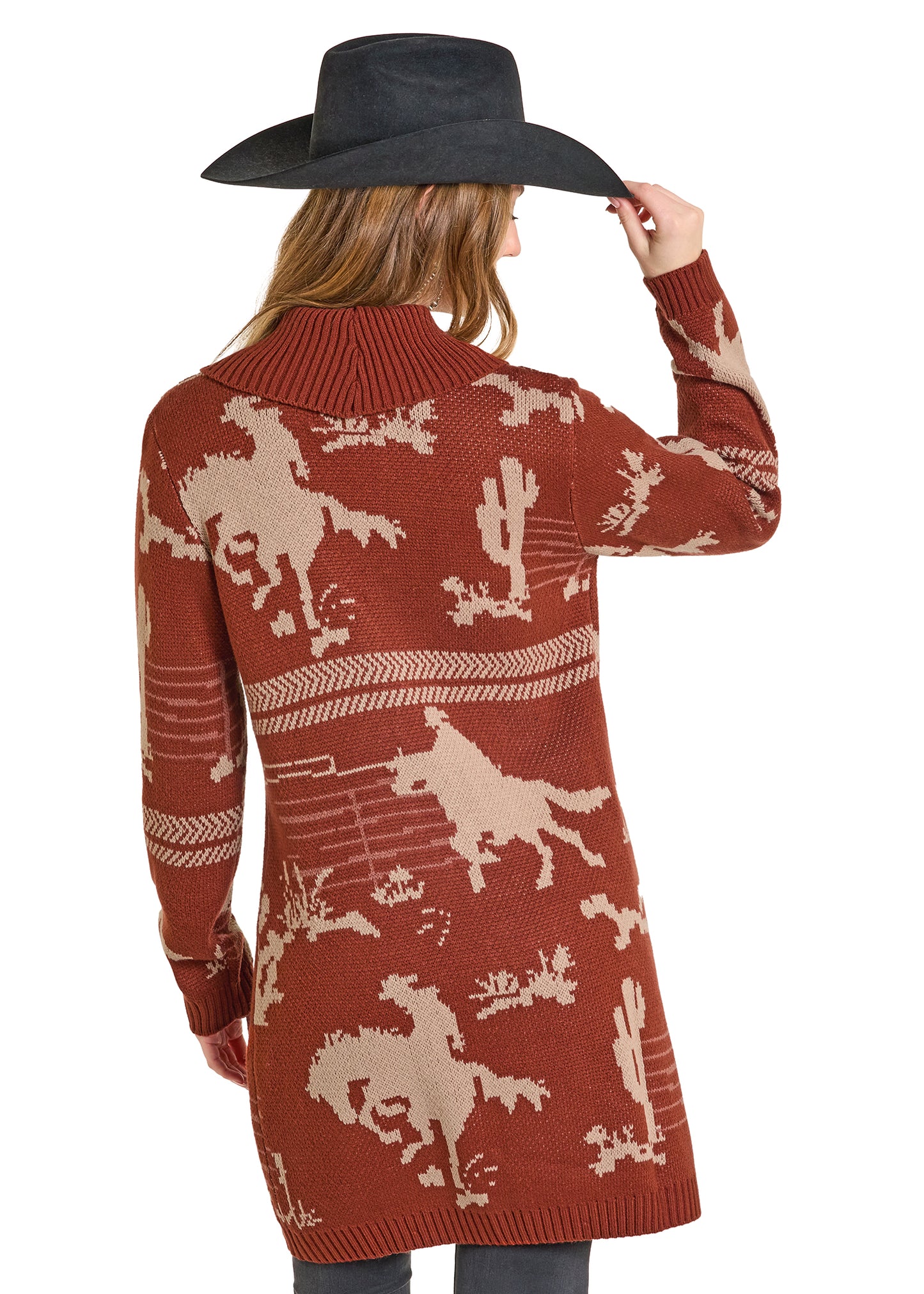 Woman wearing a brown cardigan with horse patterns on a white background