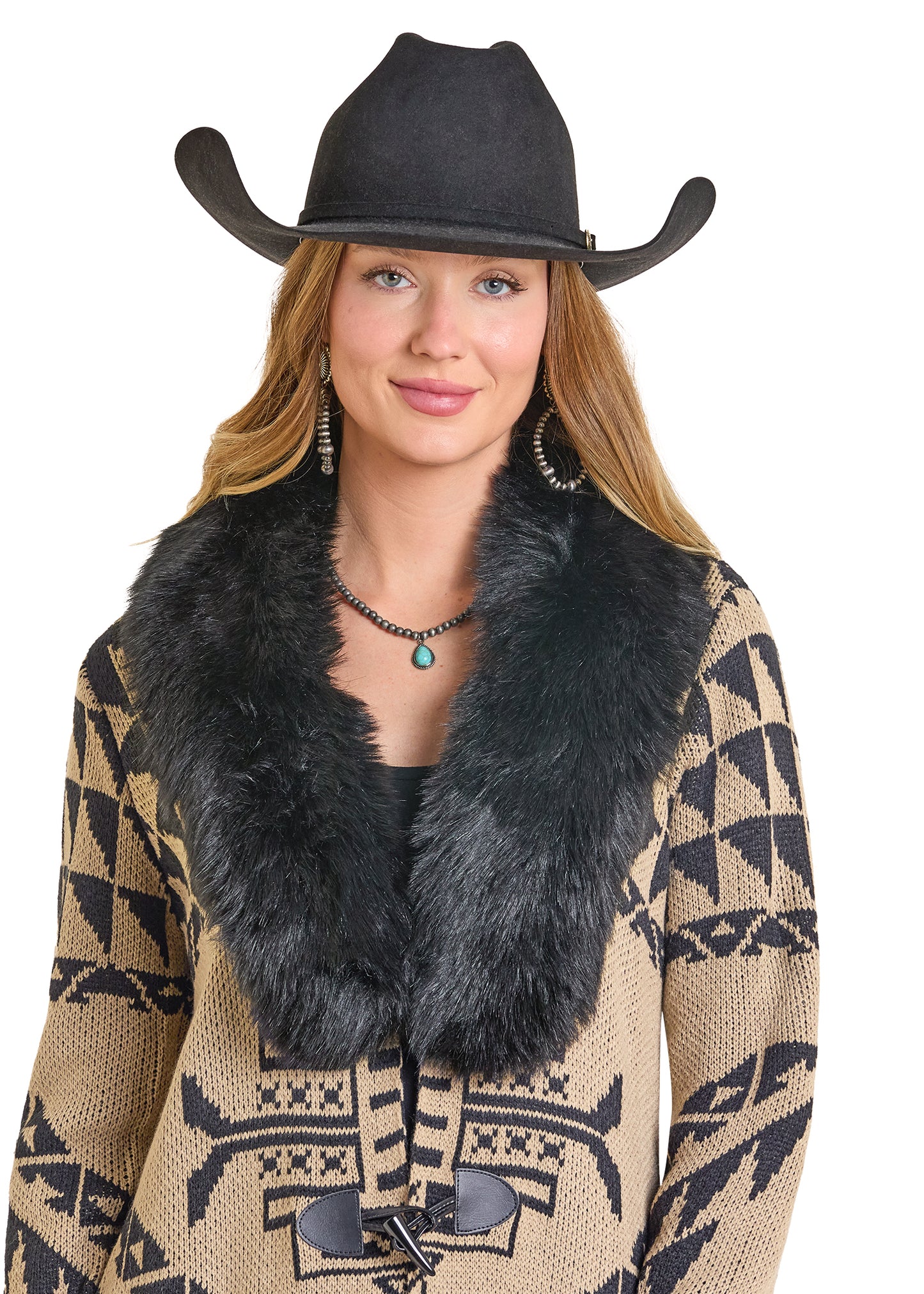 Woman wearing a black cowboy hat and patterned jacket with a fur collar on a white background