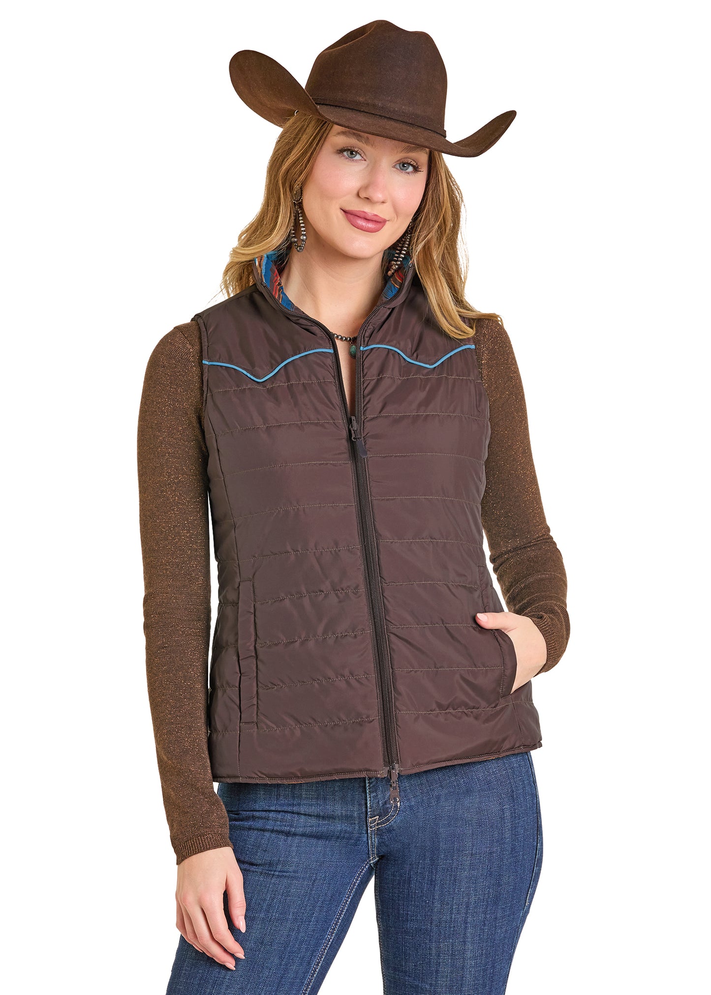 Woman wearing a brown quilted vest and cowboy hat on a white background